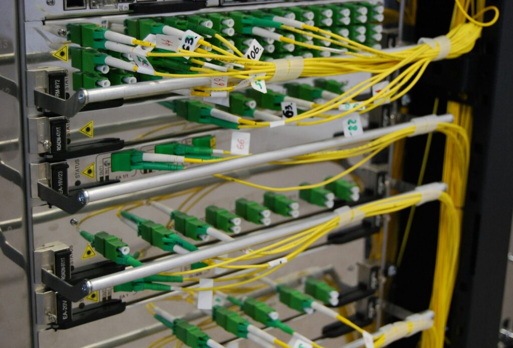 Yellow fibre optic patch cords connected in a network rack