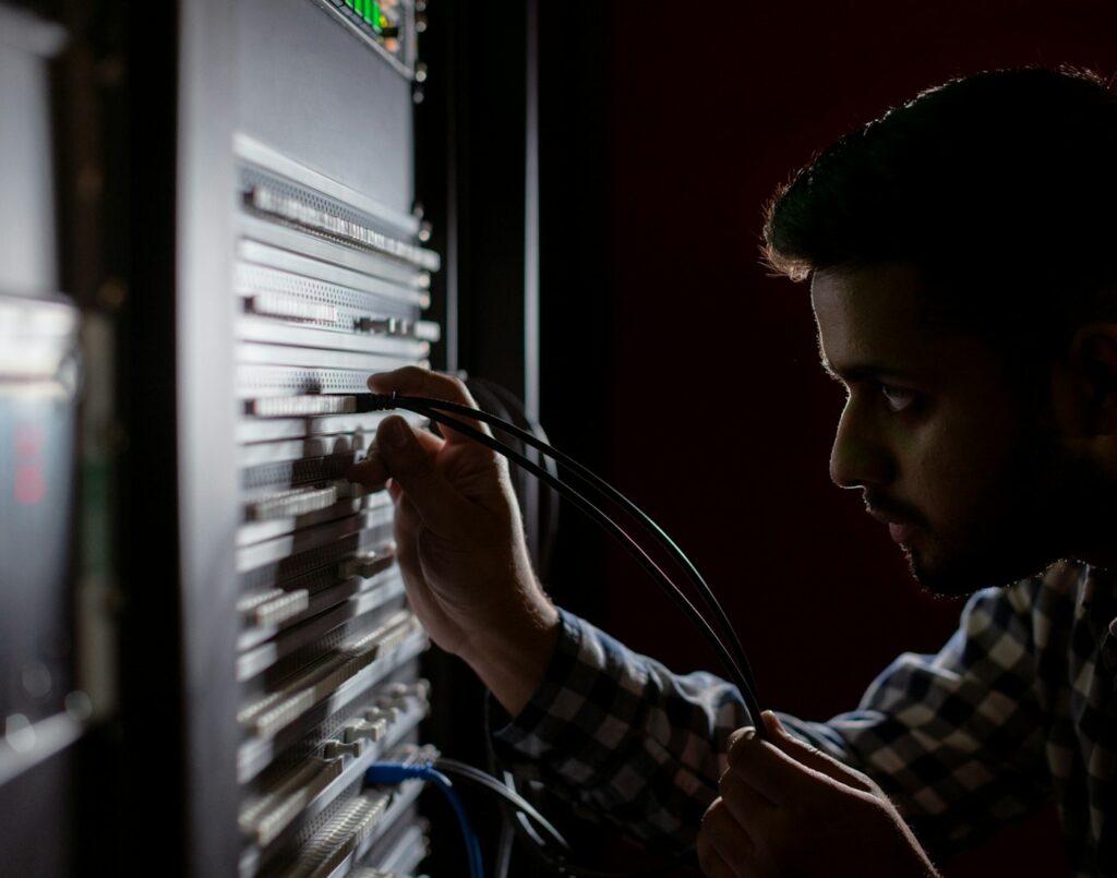 Network engineer working on equipment in a server rack