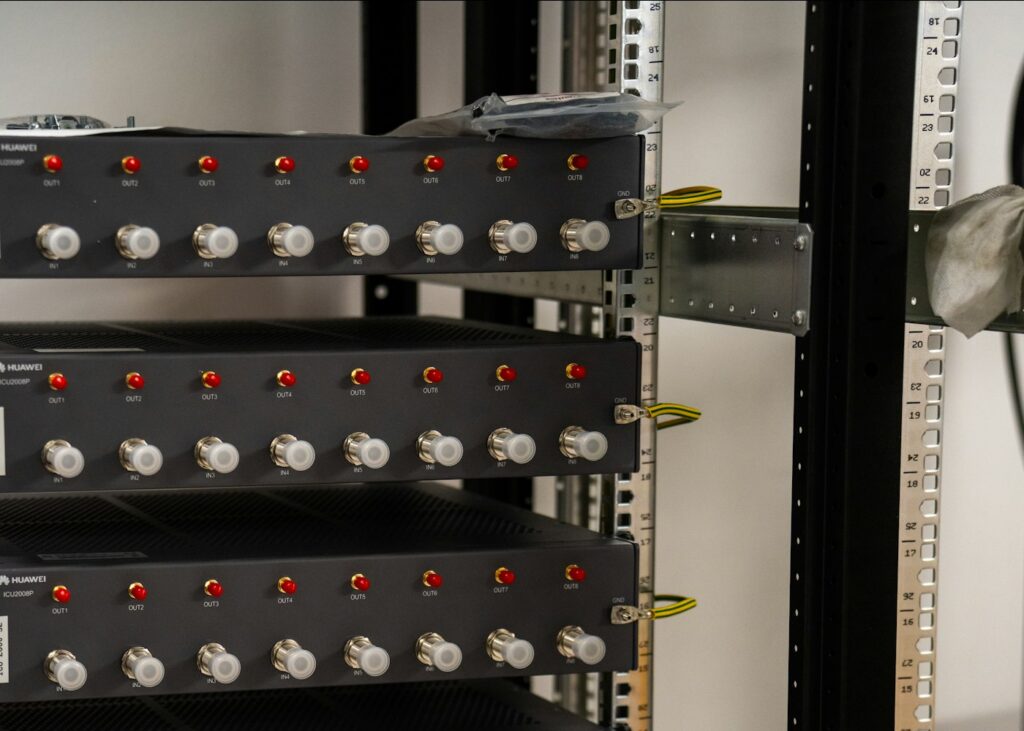 Technician testing network cabling at a rack